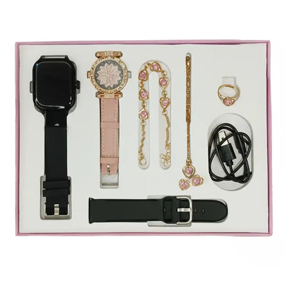 Collection of jewelry and accessories including a watch, necklace, ring, and USB cable in a box.