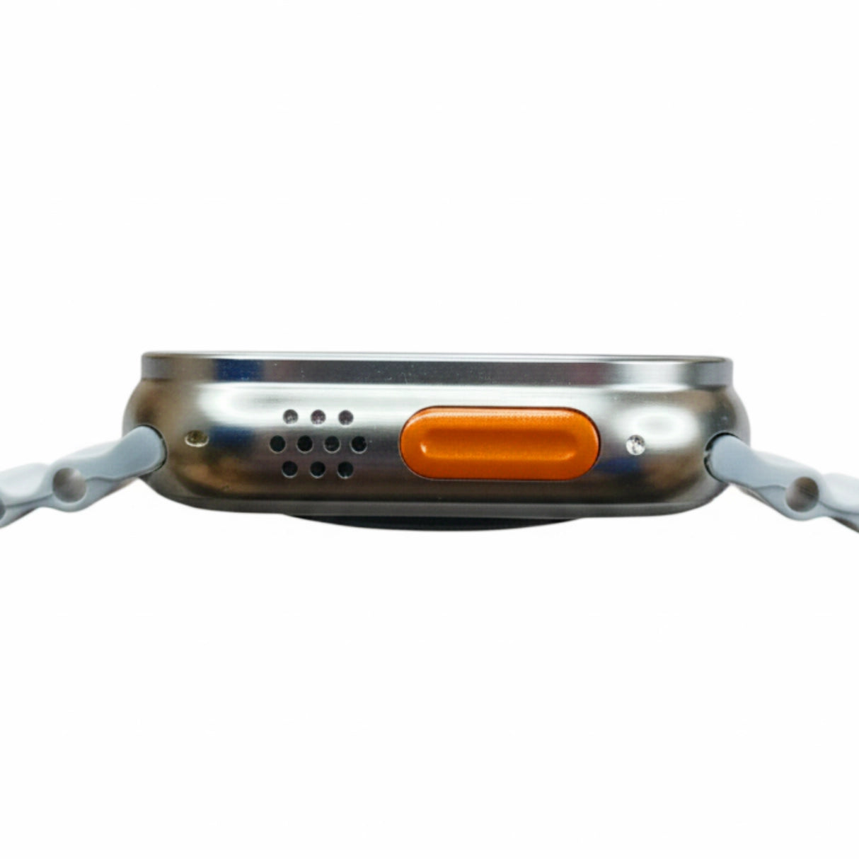 Close-up of a metallic object with an orange button on a white background